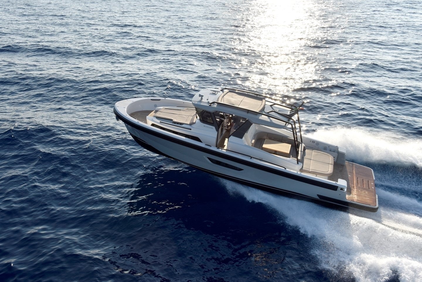 Bluegame BG42 underway, starboard side profile showing walkaround deck and helm station
