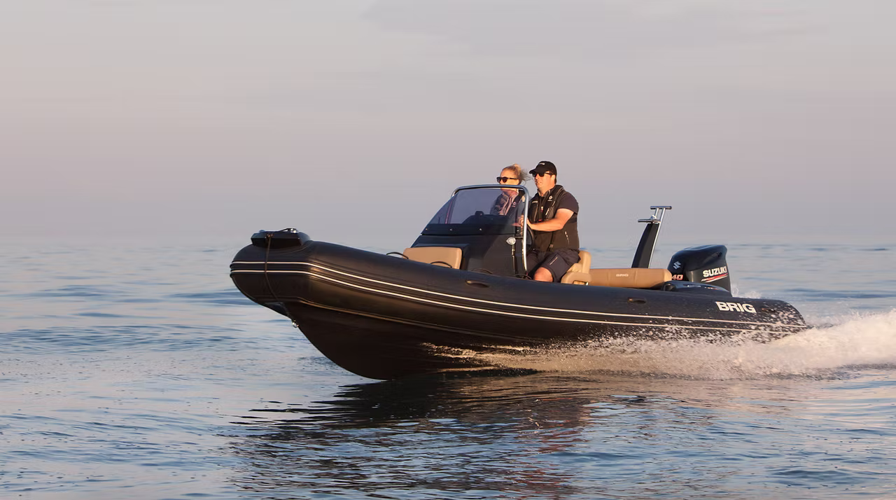 BRIG Eagle 6 RIB underway on open water with two persons aboard